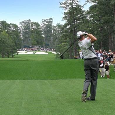 Golfer tees off at the Augusta National Golf Cours